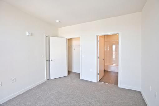A white room with two open doors.