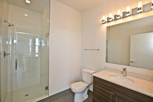 A white toilet sits next to a sink in a bathroom.