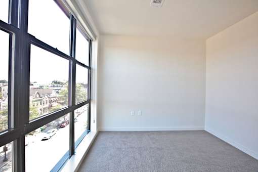 A large empty room with a view of the street outside.