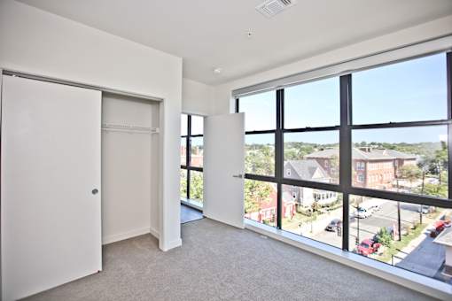 A large, empty room with a view of the street outside.