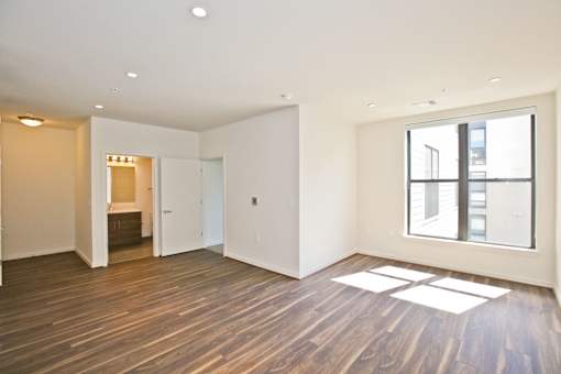 A room with wooden floors and a large window.