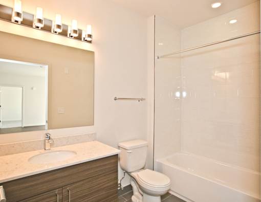 A bathroom with a sink, toilet, and bathtub.