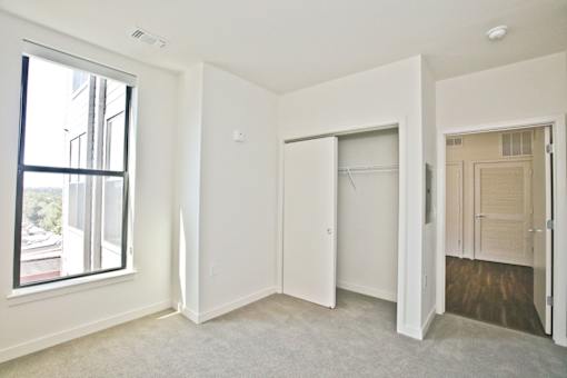 A white room with a window and a door.