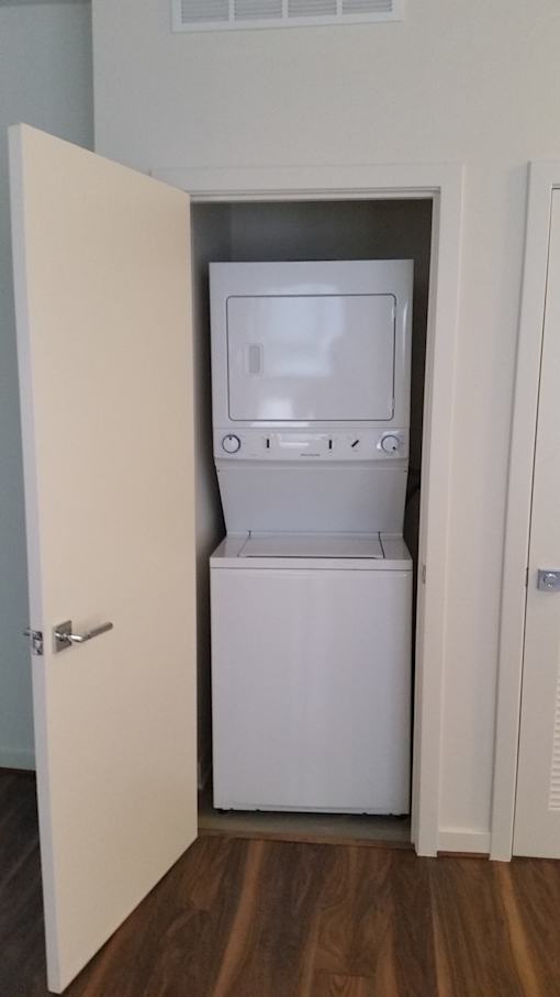 A white dishwasher is in a small room.
