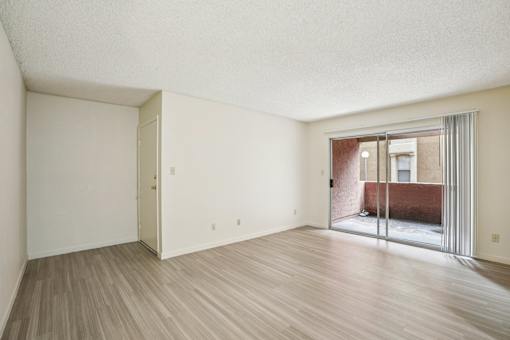 A room with a wooden floor and white walls.