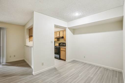 A room with a wooden cabinet and a microwave on top of it.