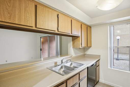 A kitchen with wooden cabinets and a white counter top.