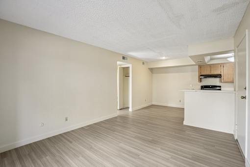 A room with a white door and a white cabinet with a black object on top.