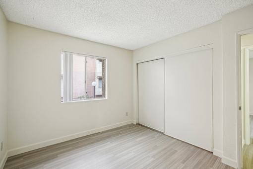 A room with a window and a door.