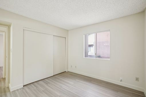 A room with a window and a sliding door.