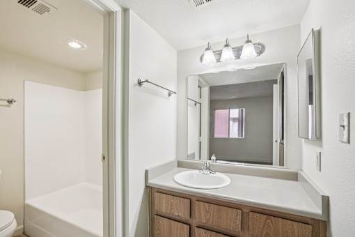 A bathroom with a white tub and sink.