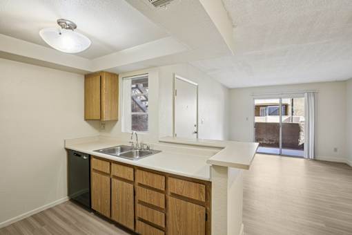 A kitchen with wooden cabinets and a white countertop.