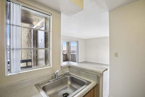 A kitchen with a sink and a window.