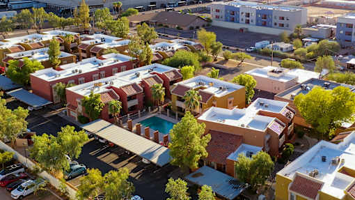 A bird's eye view of a residential area with a swimming pool.