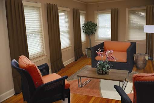 A living room with a sofa, chairs, and a coffee table.