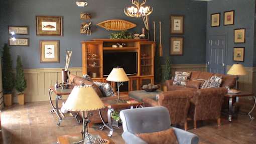 A living room with a grey armchair and a yellow lamp.