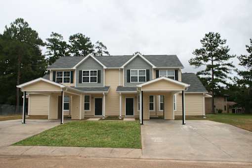 A large house with a grey roof and a grey garage door.