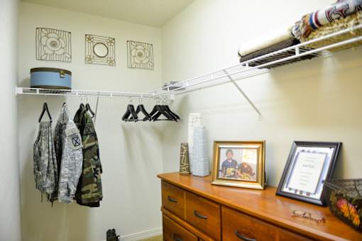 Clothes hanging on a rack in a room.