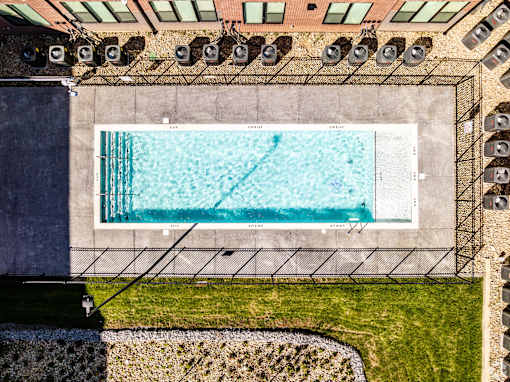 A rectangular pool with a diving board on the side.