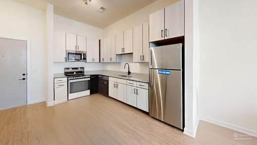 A kitchen with white cabinets and stainless steel appliances.