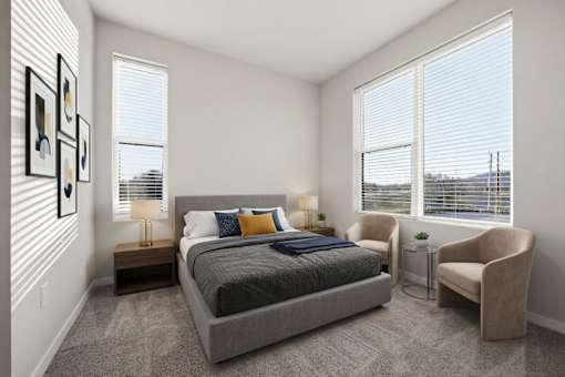 A bedroom with a large bed, a chair, and a window with blinds.