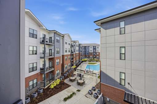 Apartment complex with a pool and landscaping.