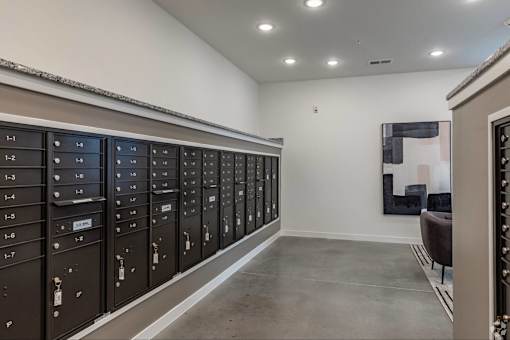 A row of mailboxes are lined up against a wall.