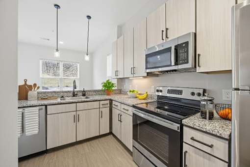 A kitchen with a stove, oven, and refrigerator.
