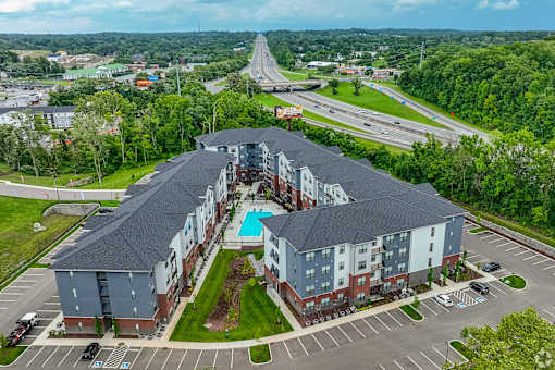 A large apartment complex with a swimming pool in the middle.