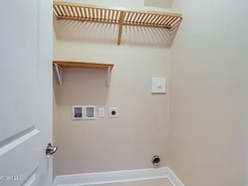 A small, empty room with a white door and a white wall.