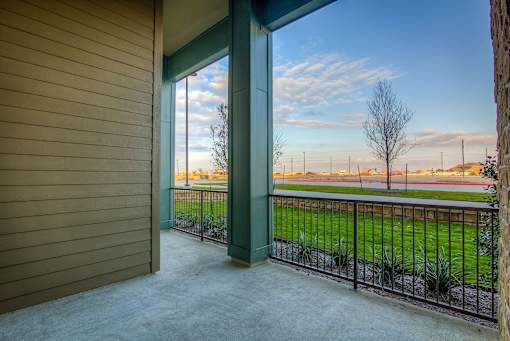 A view from a house looking out to a field.