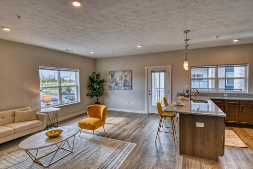 A living room with a yellow chair and a wooden table.