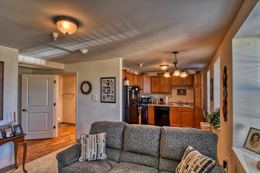 A grey couch with pillows is in the middle of a living room.
