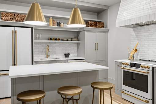 A modern kitchen with white cabinets and a white countertop.