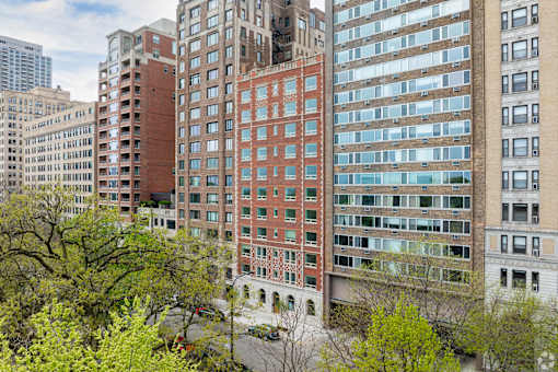A view of a city with a red building in the middle.