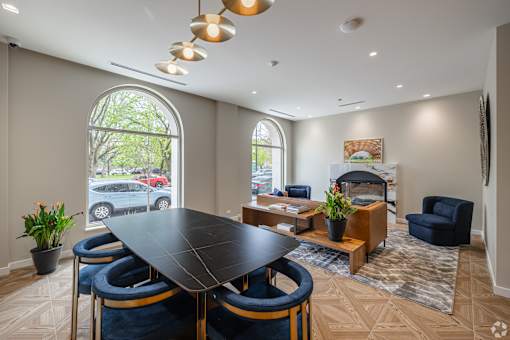 A modern dining room with a large table and chairs.