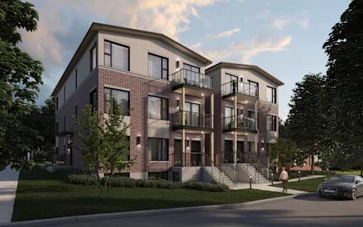 A modern apartment building with a car parked in front.