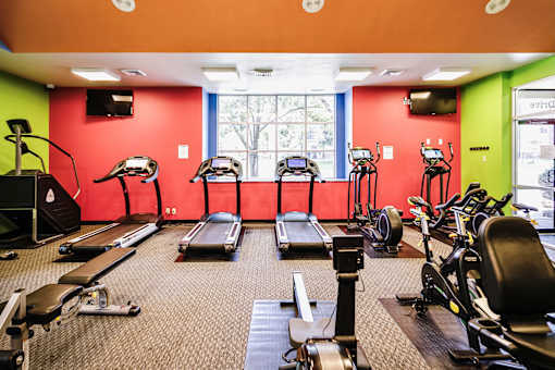 A gym with treadmills, exercise bikes, and other equipment. at The Pointe, LaVista, Nebraska