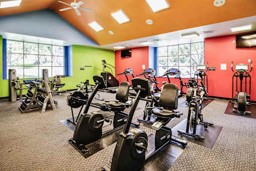 A gym with a variety of exercise equipment including treadmills, stationary bikes, and weight machines. at The Pointe, LaVista, Nebraska