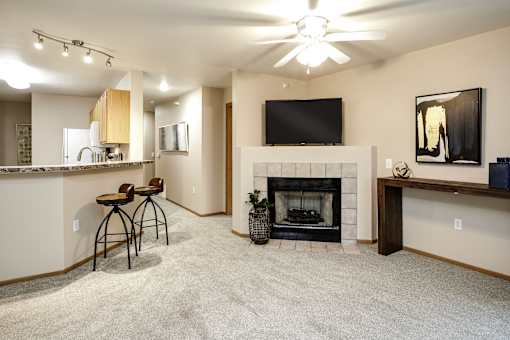 A living room with a fireplace and a television. at Tranquility Pointe, Nebraska, 68164