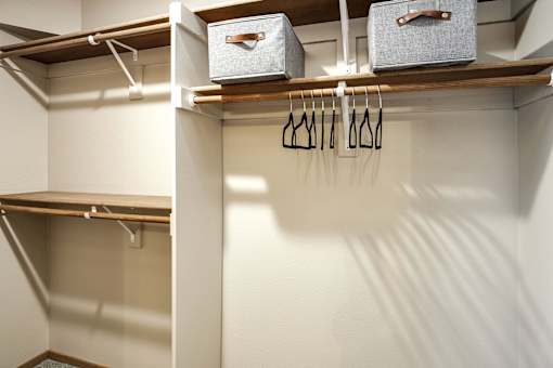 A white closet with two shelves at Tranquility Pointe, Omaha