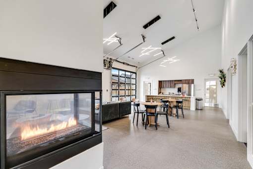 A modern living room with a fireplace and a dining area.