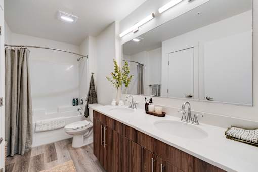 A bathroom with a white sink and a white toilet.