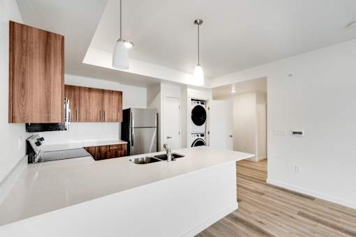 A modern kitchen with wooden cabinets and stainless steel appliances.