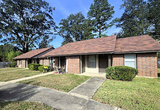A house with a brown roof and a grey door.