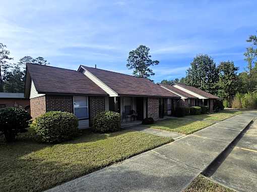 A row of houses with a clear blue sky above.