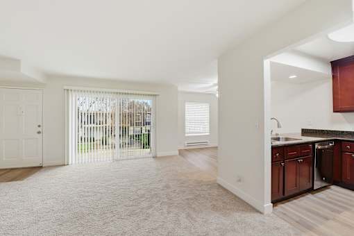 A white interior of a house with a kitchen area.