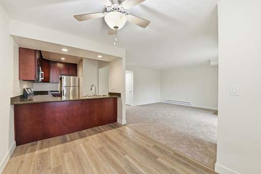 A kitchen with a brown counter and a ceiling fan.