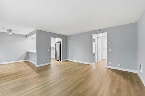 A room with wooden floors and white walls.
