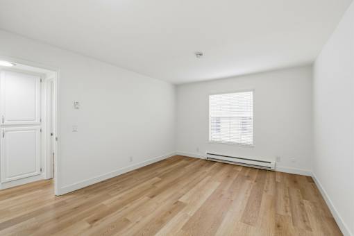 A room with wooden floors and white walls.
